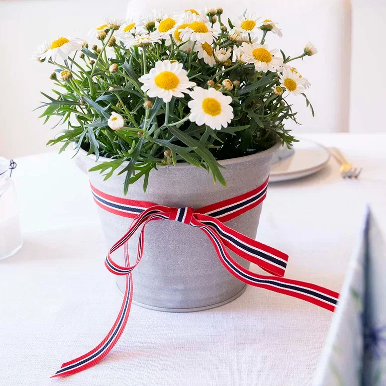 Pynt bordet til 17. mai med blomster og dekorasjoner i rødt, hvitt og blått
